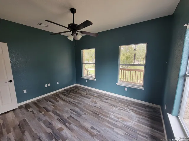 a view of a livingroom with a ceiling fan and window