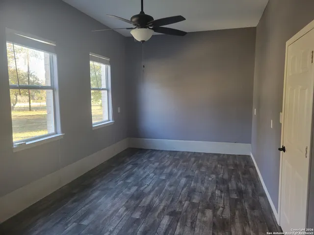 a view of a room with wooden floor and cabinet
