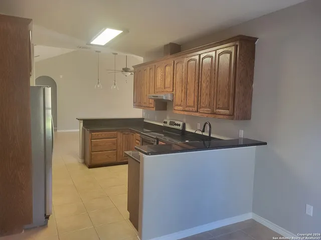 a view of a sink and a refrigerator in a kitchen