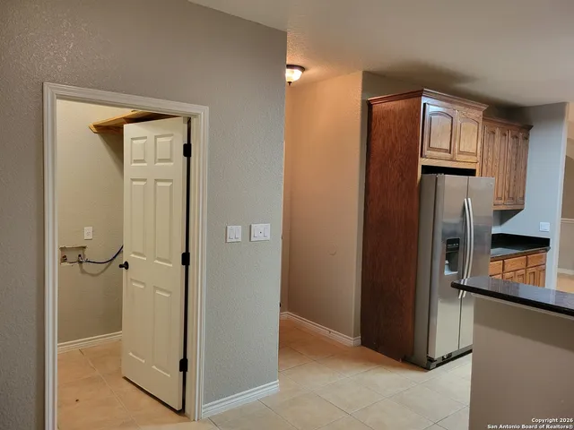 a view of an empty room with a fireplace and a window
