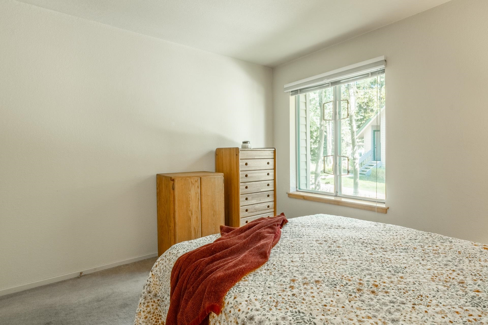 609 Golden Creek Road, Unit 609 Mammoth Lakes, CA 93546 - Photo 14 of 42 Bedroom featuring a large window with white blinds, neutral wall paint, and gray carpeting