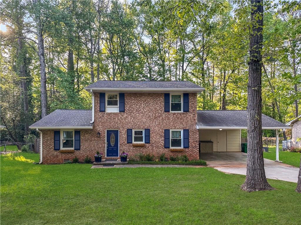a front view of a house with a garden and yard