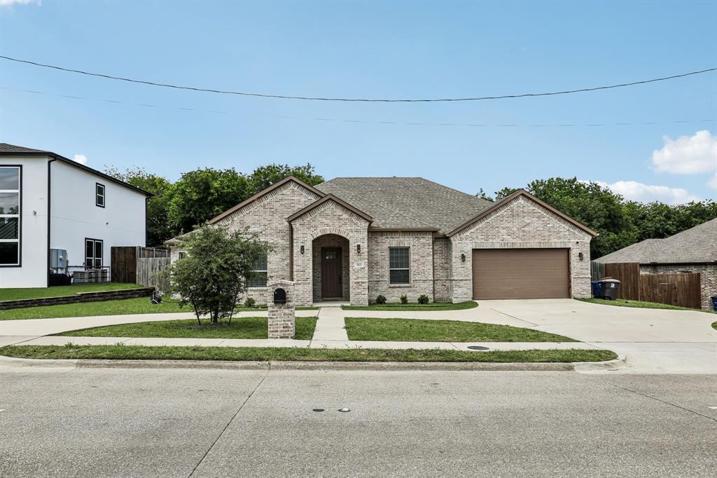 515 West Laureland Road Dallas, TX 75232 - Photo 1 of 32 a front view of a house with a yard and garage