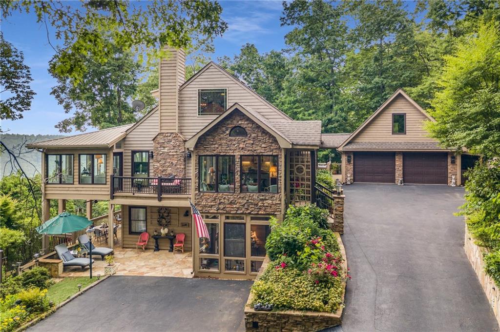 1545 Petit Ridge Drive Big Canoe, GA 30143 - Photo 1 of 1 a front view of a house with garden