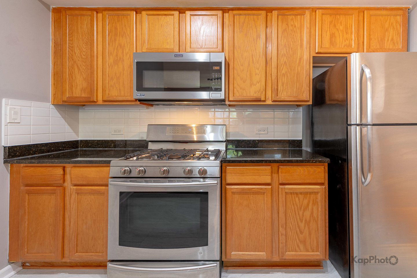 2142 West Madison Street, Unit 1 Chicago, IL 60612 - Photo 11 of 27 a kitchen with stainless steel appliances white cabinets and a stove top oven