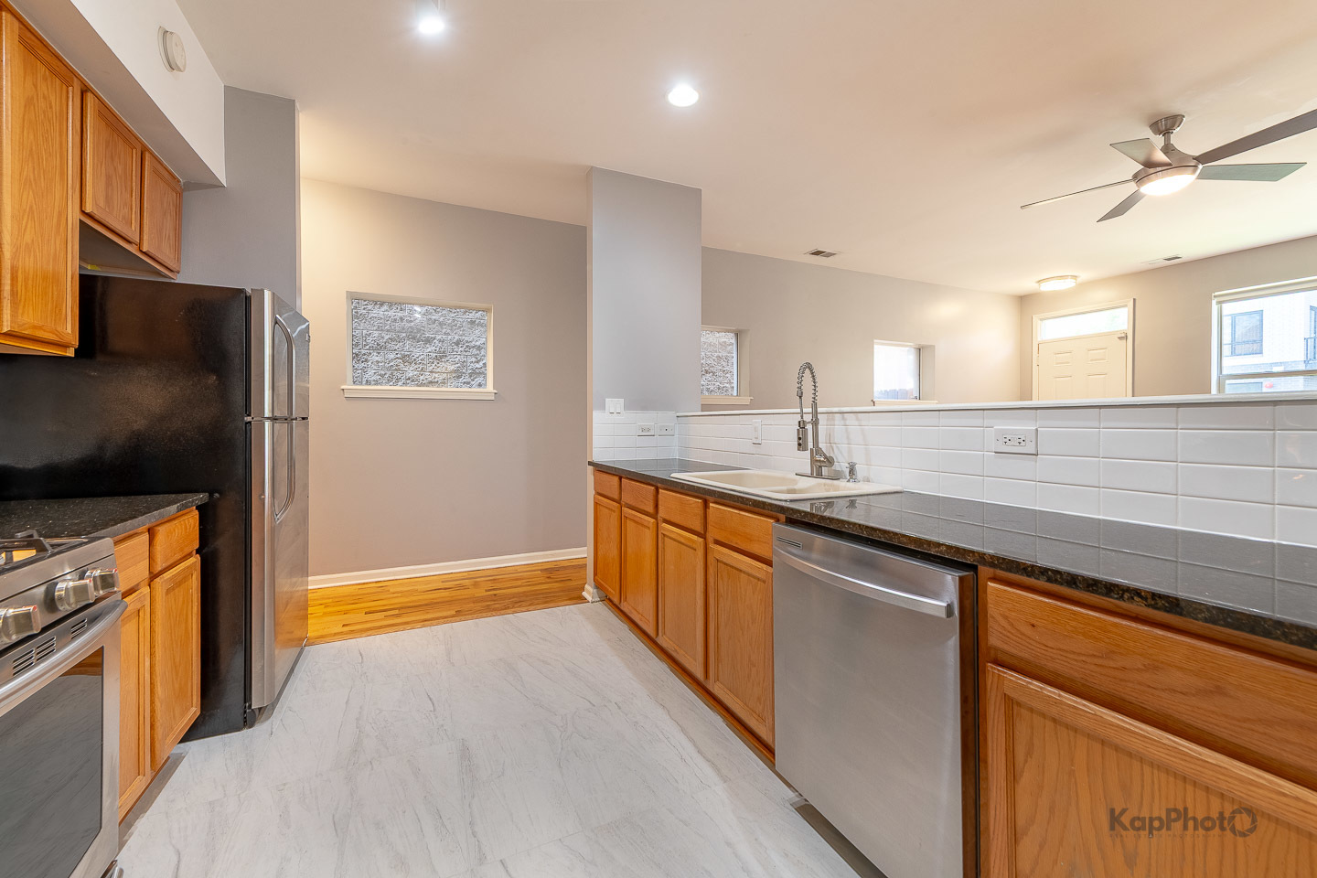 2142 West Madison Street, Unit 1 Chicago, IL 60612 - Photo 12 of 27 a kitchen with stainless steel appliances granite countertop a sink stove and refrigerator