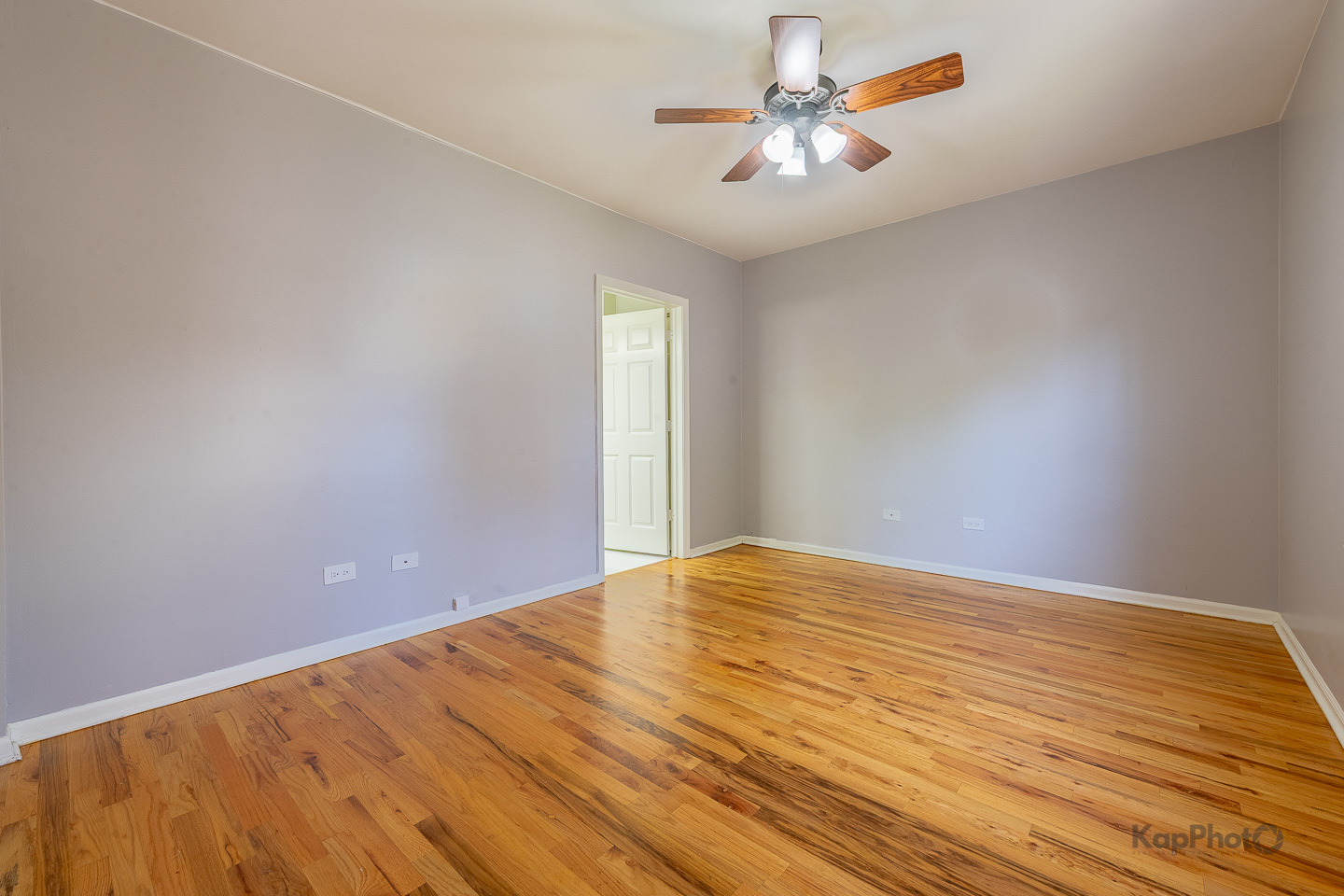 2142 West Madison Street, Unit 1 Chicago, IL 60612 - Photo 13 of 27 a view of an empty room with chandelier fan and wooden floor