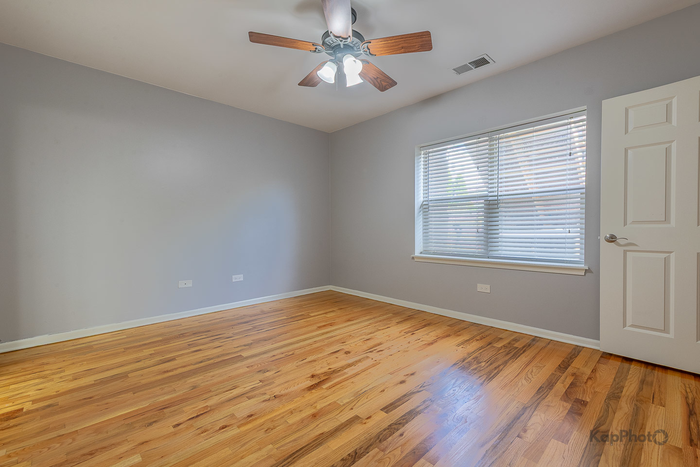 2142 West Madison Street, Unit 1 Chicago, IL 60612 - Photo 18 of 27 wooden floor in an empty room with a window