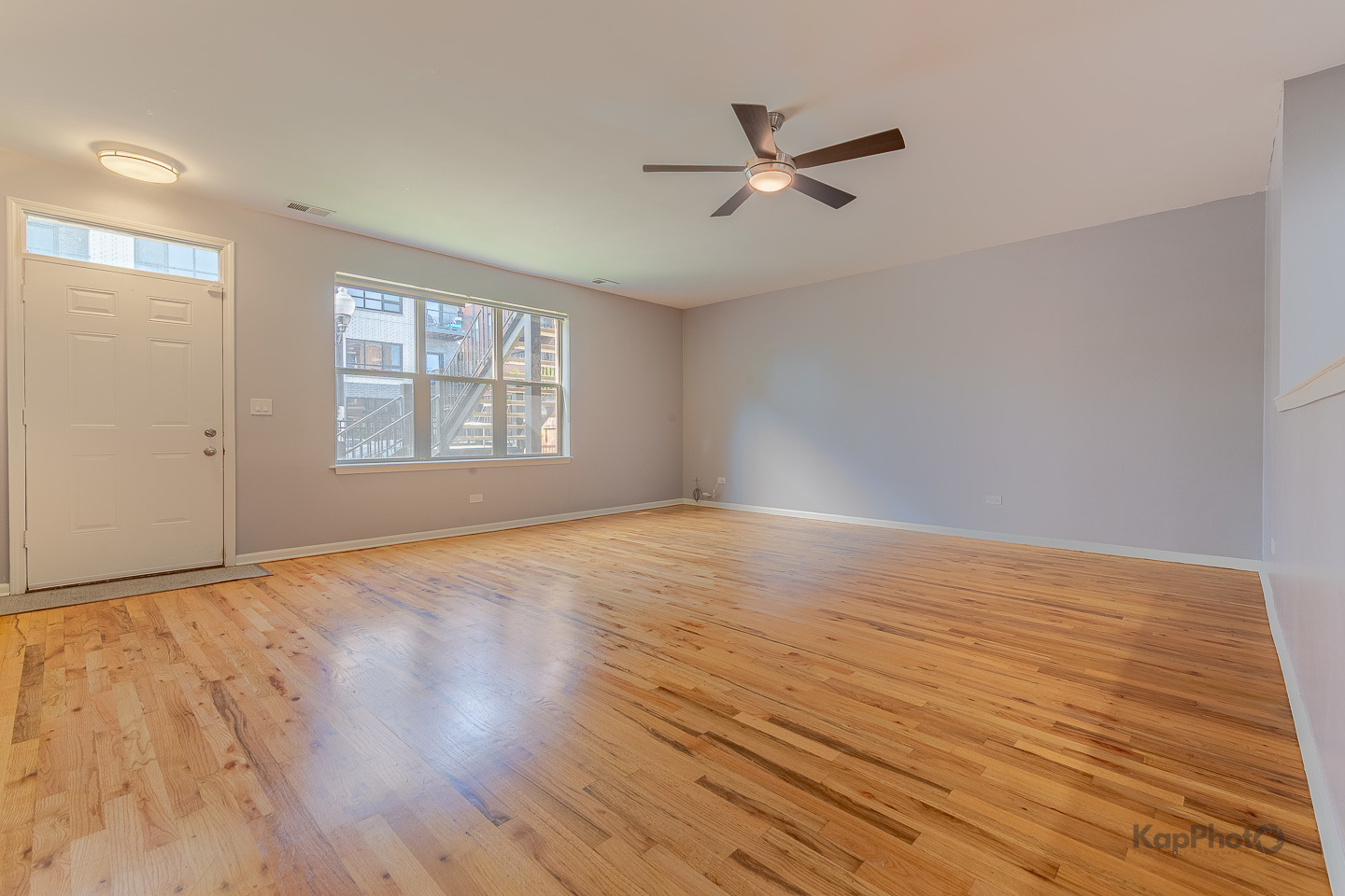 2142 West Madison Street, Unit 1 Chicago, IL 60612 - Photo 3 of 27 a view of empty room with wooden floor and fan