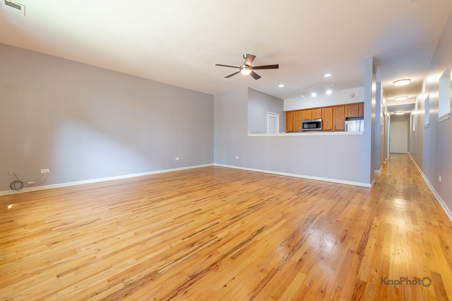 2142 West Madison Street, Unit 1 Chicago, IL 60612 - Photo 4 of 27 a view of empty room with wooden floor and fan