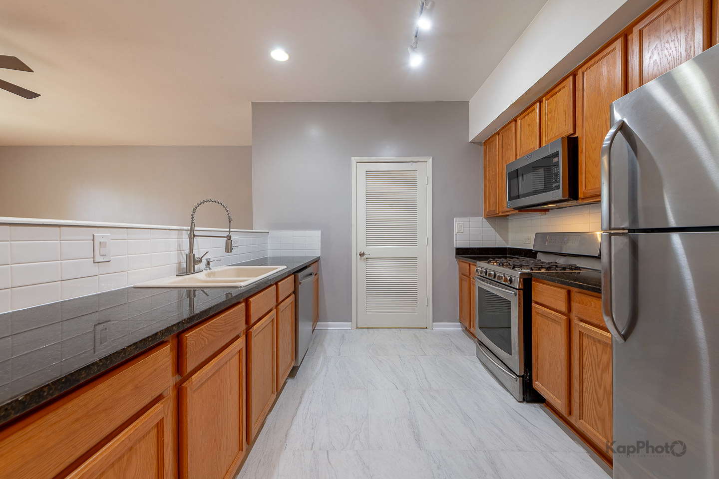 2142 West Madison Street, Unit 1 Chicago, IL 60612 - Photo 8 of 27 a kitchen with stainless steel appliances granite countertop a sink stove and refrigerator