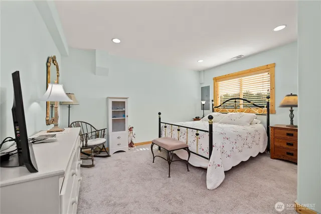 a bedroom with furniture and a window