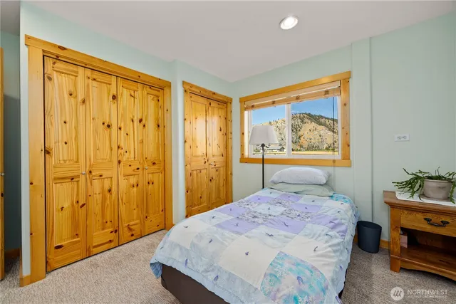 a bedroom with a bed and a painting on the wall