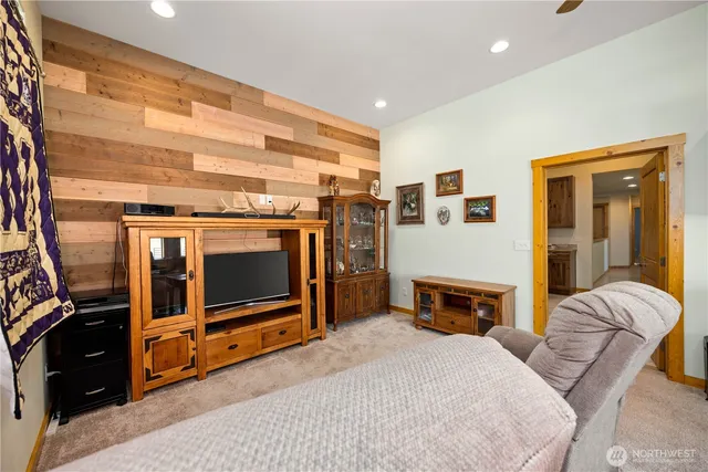 a bedroom with furniture and a flat screen tv