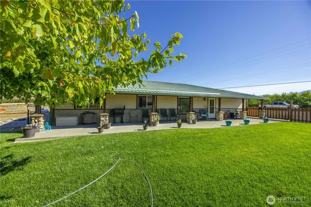a front view of house with yard and outdoor seating