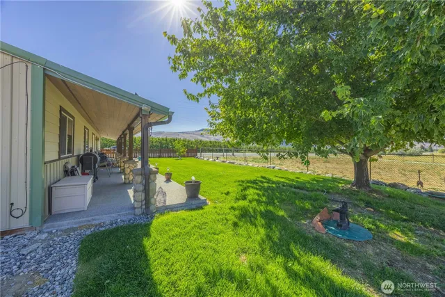 a view of a backyard with sitting area
