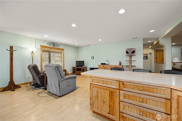a living room with furniture a flat screen tv and a dresser