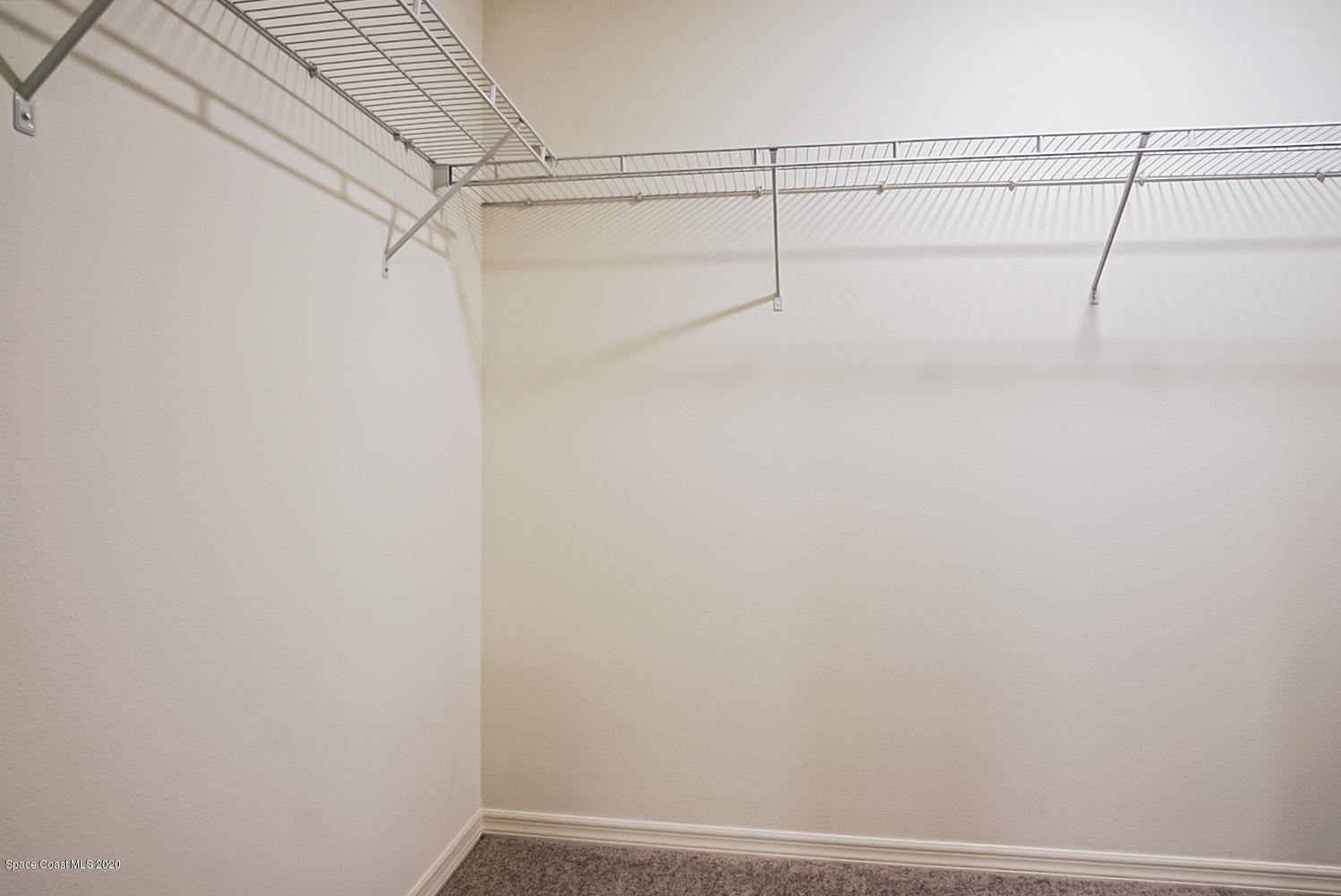 1762 Hydrangea Road Palm Bay, FL 32907 - Photo 10 of 22 a view of a room with racks on the wall