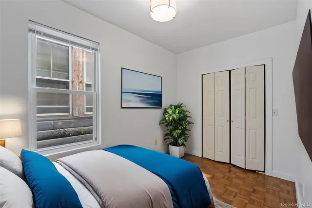 a bedroom with a bed and a window