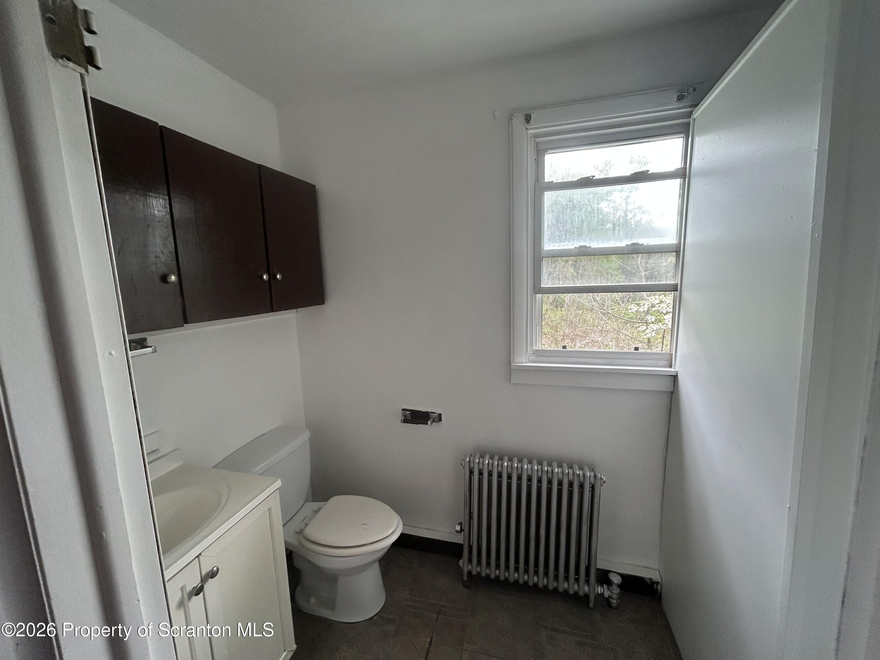 717 East Elm Street, Unit REAR Scranton, PA 18505 - Photo 3 of 9 a bathroom with a toilet a sink and a window