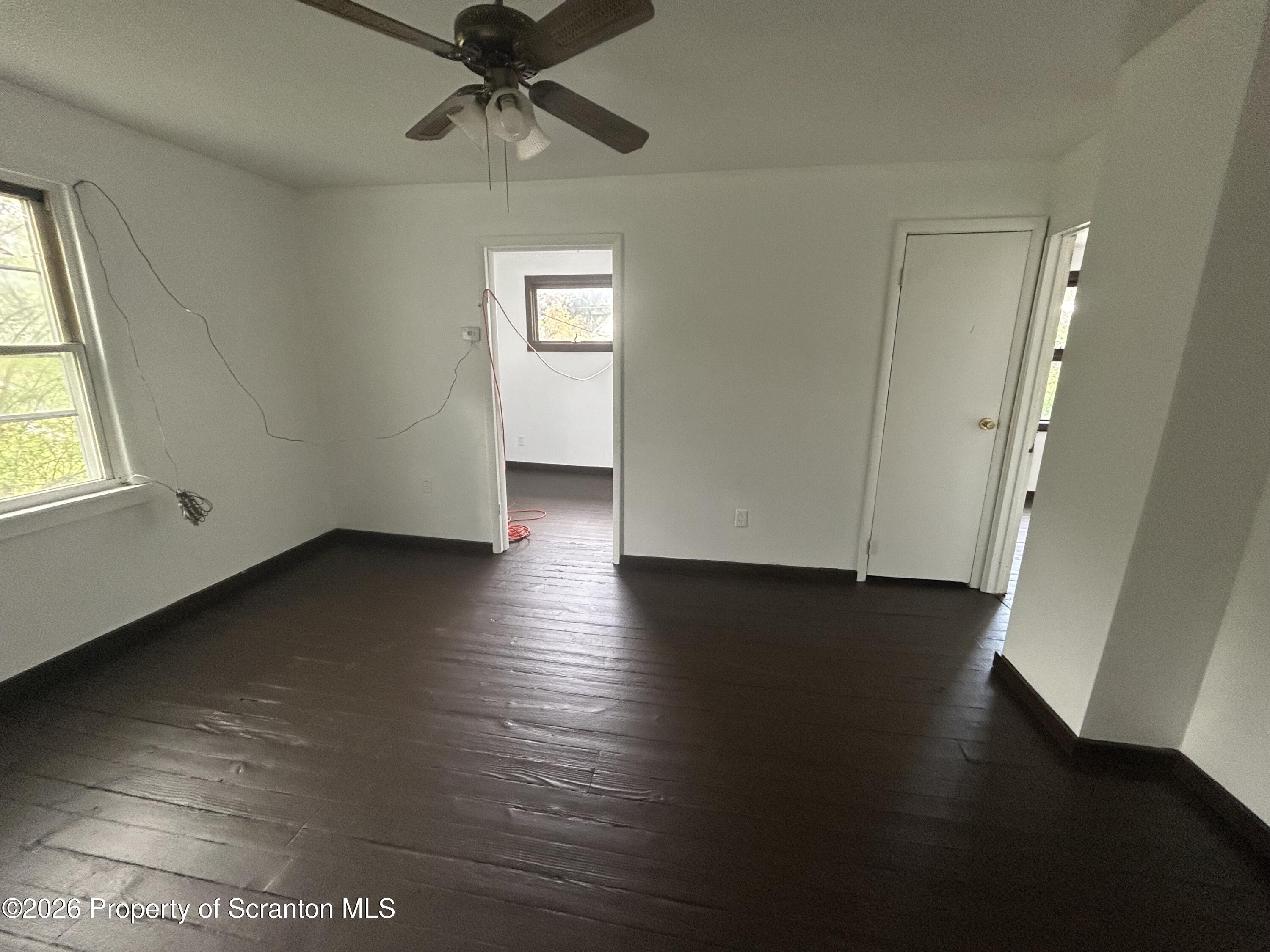 717 East Elm Street, Unit REAR Scranton, PA 18505 - Photo 9 of 9 an empty room with wooden floor cabinet and windows