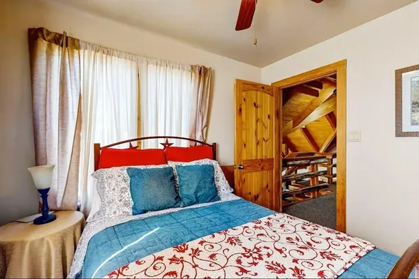 a bedroom with a bed and a window