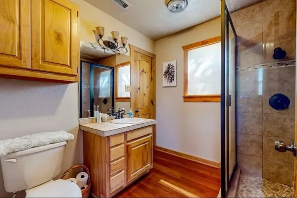 a bathroom with a sink a toilet and shower