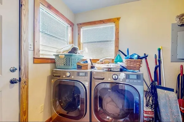 a utility room with dryer washer and a window