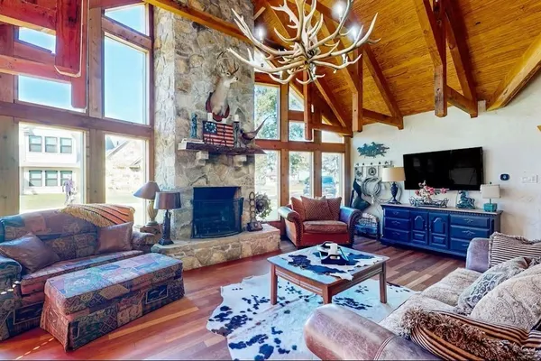 a living room with furniture a flat screen tv and a fireplace