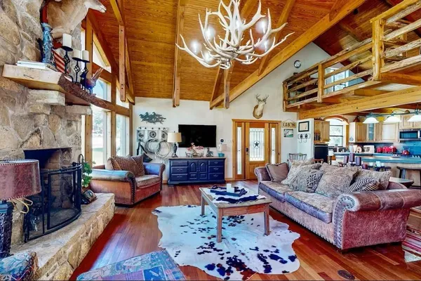 a living room with fireplace furniture and a fireplace