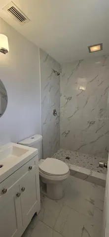 a bathroom with a toilet sink and shower
