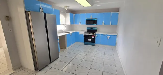 a kitchen with stainless steel appliances a refrigerator and a stove