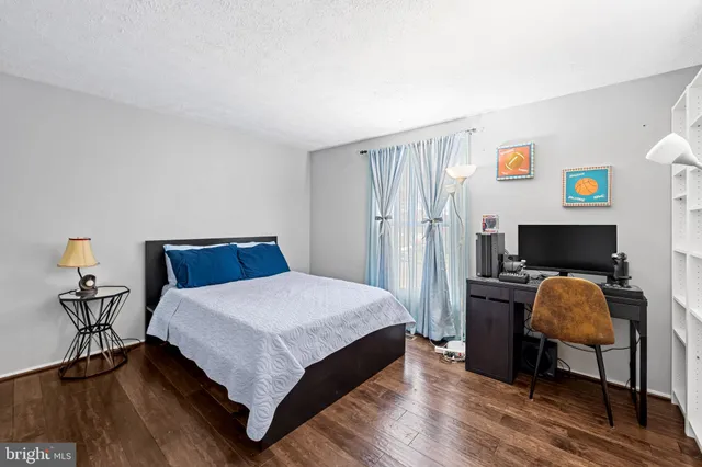 a bedroom with a bed and a desk