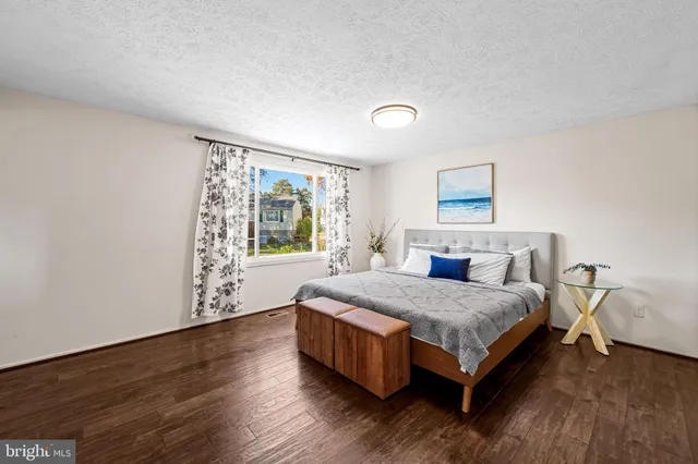 a spacious bedroom with a bed and window