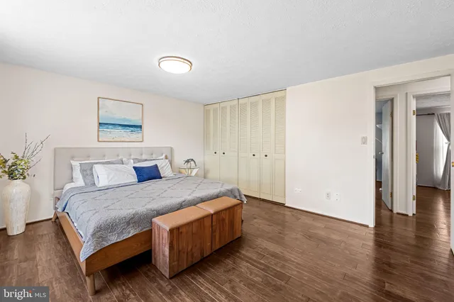 a room with a bed and wooden floor