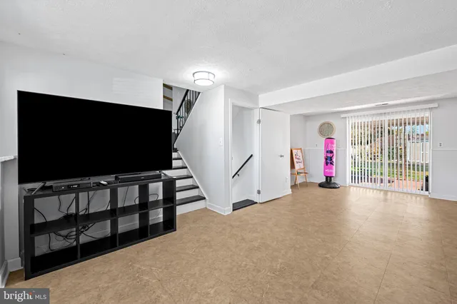 a view of a livingroom with furniture and a flat screen tv
