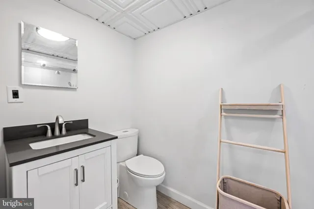 a bathroom with a toilet sink and mirror