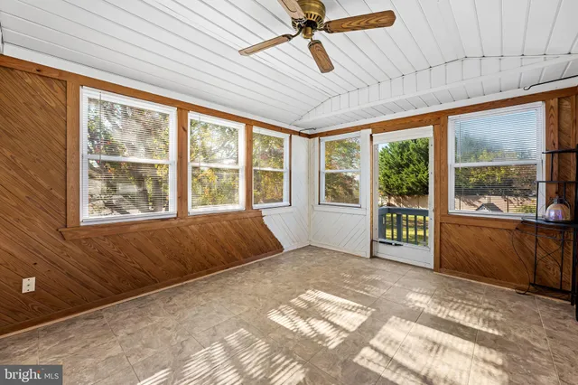a spacious bedroom with a large bed and a large window