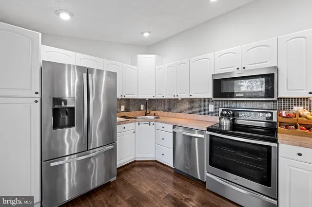 a kitchen with a refrigerator stove and microwave