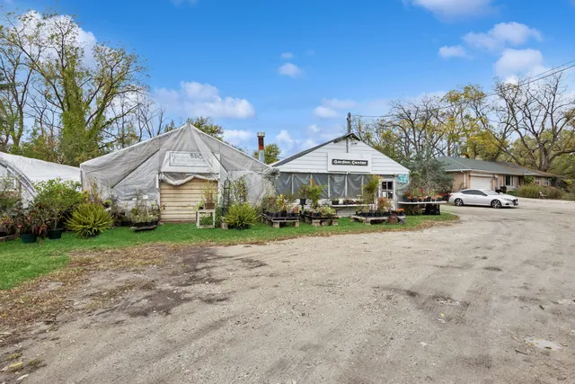 a front view of a house with yard and hallway