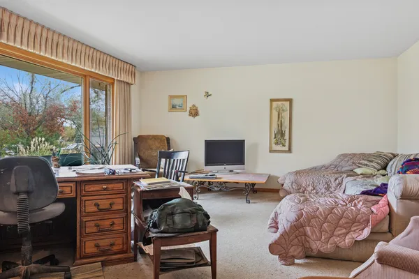 a bedroom with furniture and a window