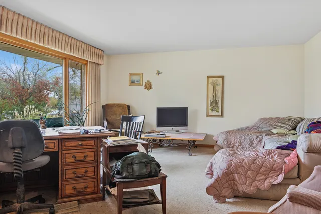 a bedroom with furniture and a window