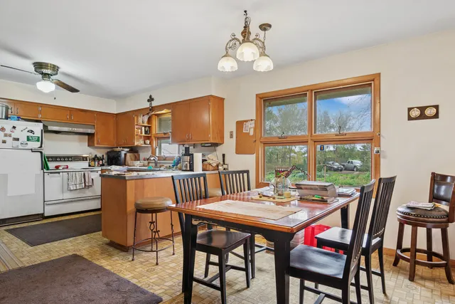 a dining room with furniture a window and a kitchen view