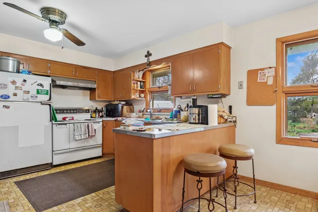 a kitchen with stainless steel appliances granite countertop a stove and a refrigerator