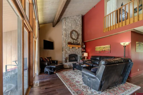 a living room with furniture a fireplace and a flat screen tv