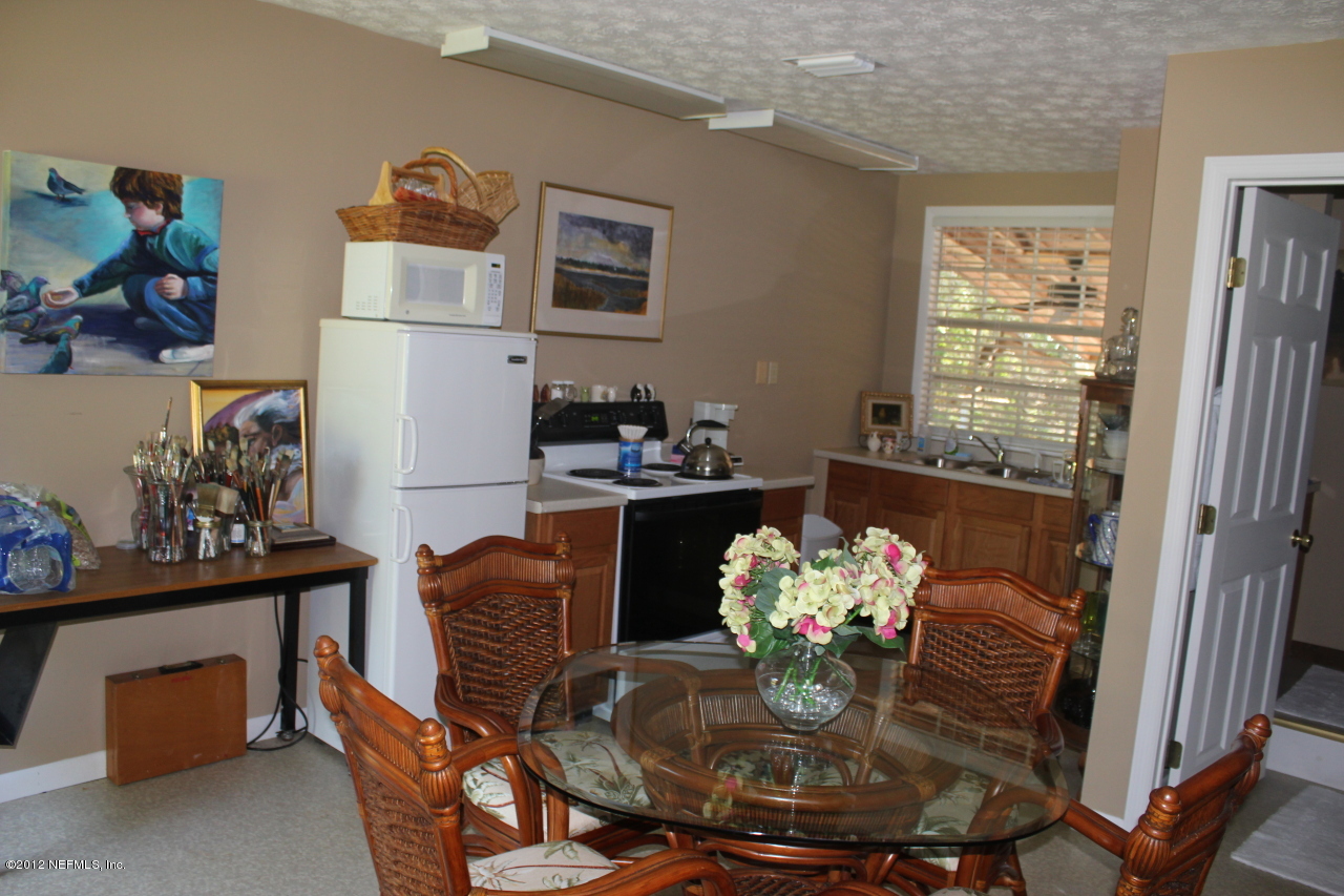 6675 Brooklyn Bay Road Keystone Heights, FL 32656 - Photo 16 of 16 a view of a dining room with furniture a kitchen and a window