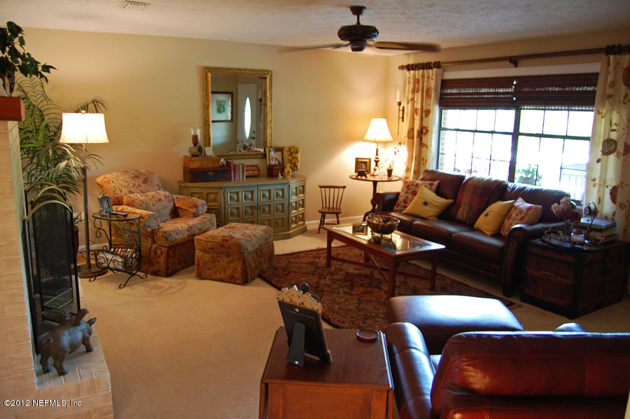 6675 Brooklyn Bay Road Keystone Heights, FL 32656 - Photo 8 of 16 a living room with furniture a window and a chandelier