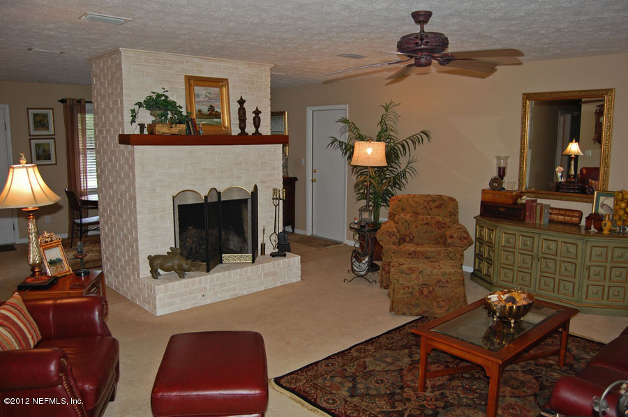 6675 Brooklyn Bay Road Keystone Heights, FL 32656 - Photo 9 of 16 a living room with furniture and a fireplace