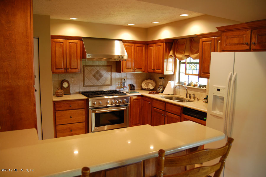 6675 Brooklyn Bay Road Keystone Heights, FL 32656 - Photo 10 of 16 a kitchen with a sink a stove and refrigerator
