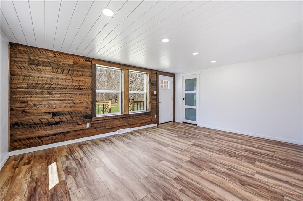 311 Oakdale Road Darlington, PA 16115 - Photo 13 of 32 a view of an empty room with a window and wooden floor